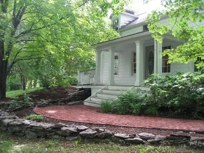 a white house with a stone walkway in front of it at Omega Special, Sun thru thurs 5 night minimum in Clinton Corners