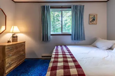 a bedroom with a bed and a window at Retro Retreat Charming Home with Hot Tub & Fire Pit in Hensonville