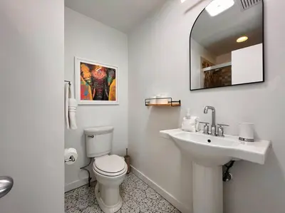 a white bathroom with a toilet and a sink at Luxury Woodstock Retreat Hot tub and heated pool in Woodstock