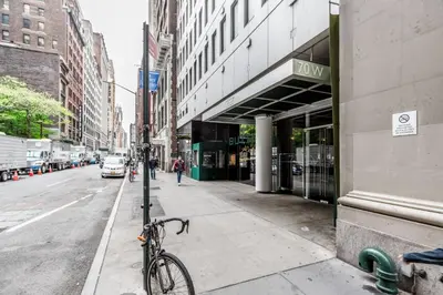 a bike parked on a sidewalk next to a street at Blueground Midtown gym wd ac nr Rock Ctr NYC-1536 in New York