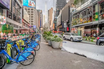 a row of blue bikes parked on a city street at Blueground Midtown West 1bd apartment NYC-1625 in New York