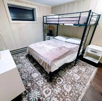 a bedroom with a bunk bed and a rug at 2BD 1BA - Mount Snow VT - Ski-Back Trail - Shuttle in Dover