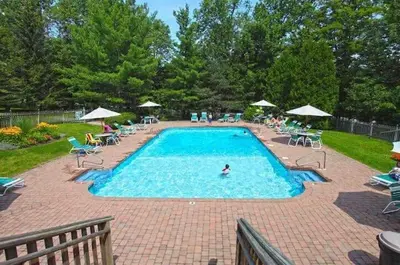 a swimming pool with a person in the water at 2BD 1BA - Mount Snow VT - Ski-Back Trail - Shuttle in Dover