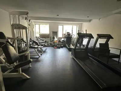 a gym with several tread machines in a room at 4 PEEPS Apt INWILLIAMSBURG in Brooklyn