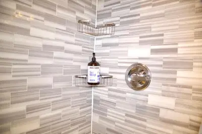a bottle of wine on a shelf in a bathroom at New2 York Style Stay near Central Park in New York
