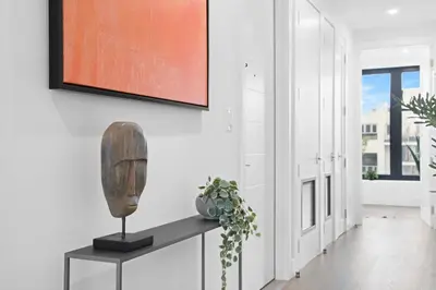 a living room with a table and a painting on the wall at 149BK-501 New 2br 2baths with a Private Terrace in Brooklyn