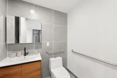 a bathroom with a white toilet and a sink at 149 Green Street in Brooklyn