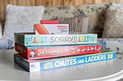 a stack of books sitting on top of a table at Ski In Ski Out Hunter Mtn Seasonal Pool Access w Panoramic Views Hike Swim Fish Unwind in Lanesville