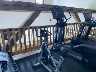 a gym with two exercise bikes on a balcony at Luxury ADA Unit - 101 in Wilmington