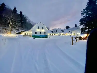 a white house in the snow at night at Luxury Townhome 107 in Wilmington