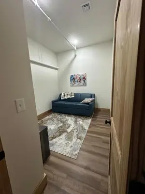 a living room with a blue couch in a room at Luxury TownHome 106 in Wilmington