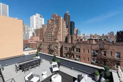 a view of a rooftop patio with a city skyline at 3BR Penthouse with Massive Private Rooftop in New York