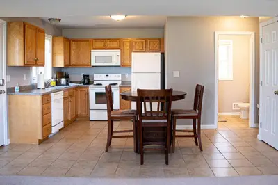 a kitchen with a table and chairs and a refrigerator at 11 - 4 Bedrooms 3 Baths Sleeps up to 10 in Plainville
