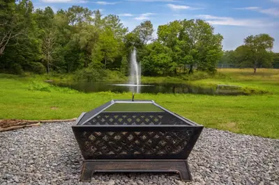 a statue in front of a fountain in a park at Farm Stay Close to Ski Adventures in Pleasant Mount