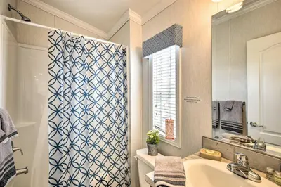 a bathroom with a sink and a shower curtain at The Hideout Cottage Close to Ski Mountain in Pleasant Mount