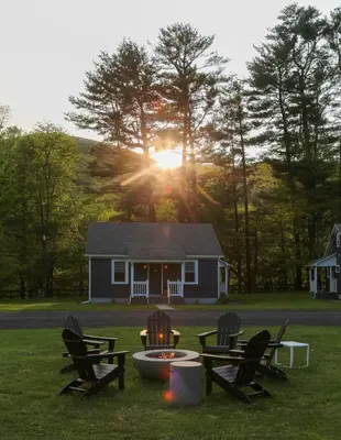 a house with chairs and a fire pit in the grass at Perch Cottages #3 - Creek Access, Sauna, Mt views in Boiceville