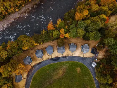 an aerial view of a house with trees and a road at Perch Cottages #7 - Creek Access, Sauna, Mt views in Boiceville