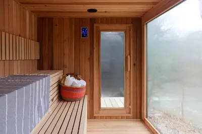 a porch of a sauna with a window and a bucket at Perch Cottages #11 - Creek Access, Sauna, Mt views in Boiceville