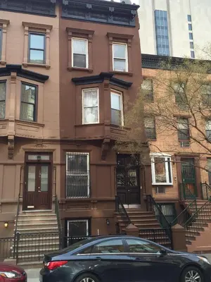 a black car parked in front of a building at Great Looking Studio Apartment in New York