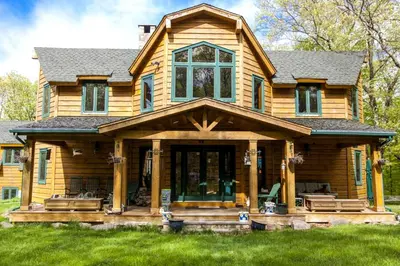 a log home with a large front porch at Country Getaway Nestled in Enchanting Westchester County near New York City in Bedford