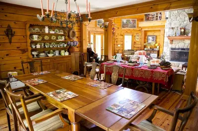 a dining room with wooden walls and a table and chairs at Country Getaway Nestled in Enchanting Westchester County near New York City in Bedford