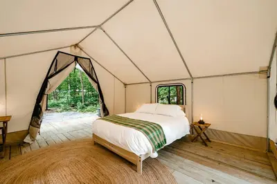 a bedroom with a bed in a tent at Gorgeous Safari Tent in the Lake George Area of the Adirondack Mountains, Perfect for a Family Weekend Away in Corinth