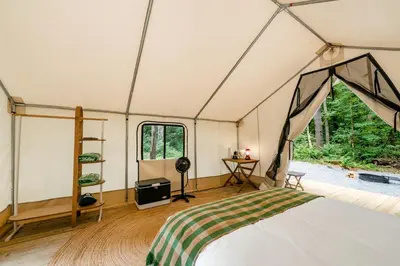 a room with a bed in a tent at Gorgeous Safari Tent in the Lake George Area of the Adirondack Mountains, Perfect for a Family Weekend Away in Corinth