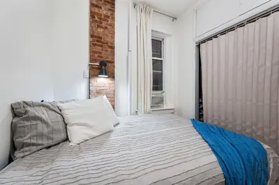 a bedroom with a bed and a window at 2BR Upper East Side near Central Park in New York