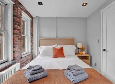 a bedroom with a bed with towels on it at Charming 3-Bedroom Apartment in Midtown West in New York