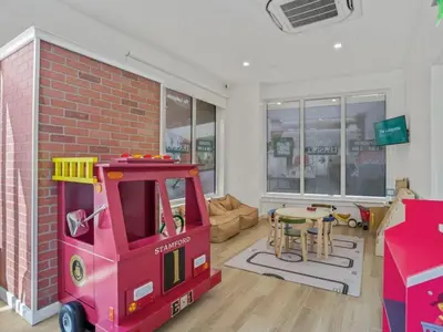 a living room with a toy fire truck and a table at The Platinum Downtown Stamford Studio Getaway in Stamford