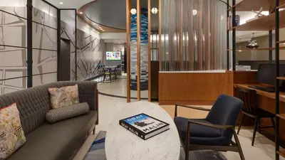 a living room with a couch and a table and chairs at The Vibe on 5th IV Vibe 8753 in New York