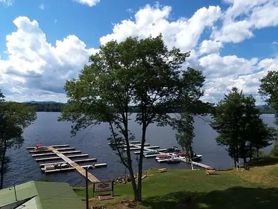 a bunch of boats are docked on a lake at Comfortable Cabin Right on Great Sacandaga Lake in Northville, New York in Northville