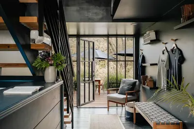 a living room with a couch and a chair at Coop 002 in Kenoza Lake