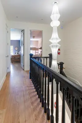 a staircase in a home with a black railing at 3.8 Million Dollar Brownstone Newly Renovated in New York