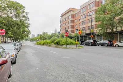 a street with cars parked on the side of the road at Blueground LIC pool wd nr Gantry Park NYC-1845 in New York