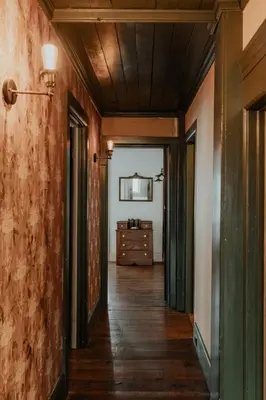 an empty hallway with a dresser in a room at Book Village Inn - Dickinson Room Queen Bed in Hobart