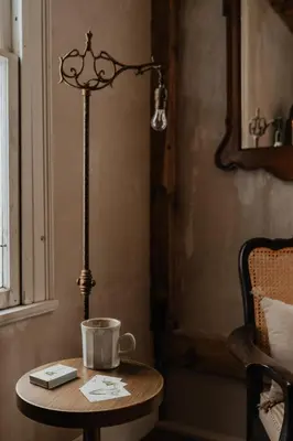 a table with a lamp and a coffee cup on it at Book Village Inn - Entire Hotel in Hobart