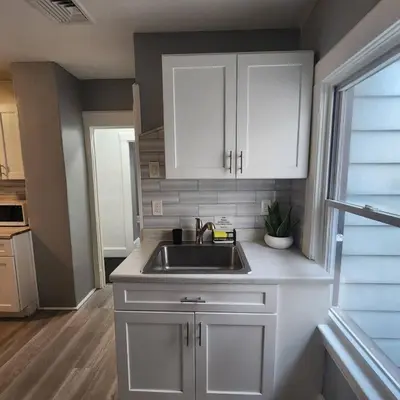 a kitchen with white cabinets and a sink at Private Bedroom In Shared Apt C in South Hackensack