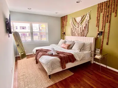 a bedroom with a bed and a window at Comfortable home close to Manhattan,Wall St & more in Jersey City