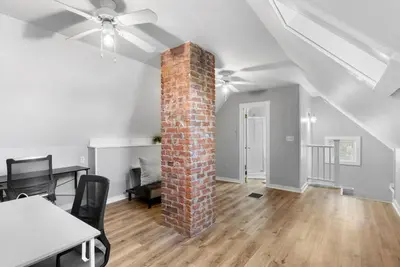 a room with a brick pillar and a table and chairs at SCSU Two Bedroom Suite in New Haven
