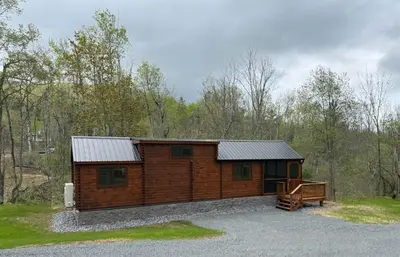a log cabin with a bench in front of it at Tiny Cabin #1 by Windham NY Escape 'Catskill Gem' in Hensonville