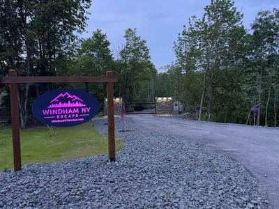 a sign for a wildlife park with a gravel road at Tiny Cabin #4 by Windham NY Escape 'Cabin Comfort' in Hensonville