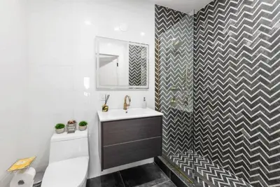 a bathroom with a sink and a toilet and a mirror at Top Notch 2BR & 2BA Suite Minutes to Central Park in New York