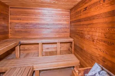 a sauna with wooden walls and wooden benches at 5B Mountain Village- Unit B in Dover
