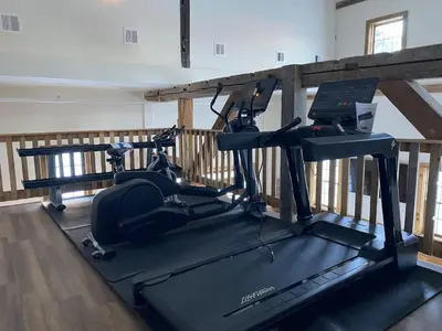 a gym with two exercise bikes on a treadmill at Luxury 2 Bedroom Townhome 102 in Wilmington