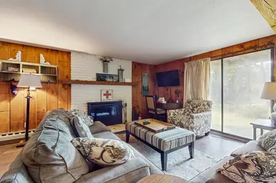 a living room with a couch and a fireplace at Ski Haus Retreat - Unit A in Dover
