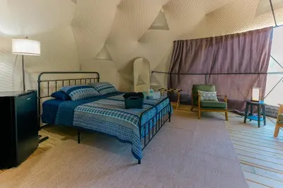 a bedroom with a bed and a tv in it at Cozy Mountain Dome Escape in the Catskills in Gilboa