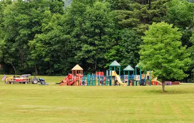 a park with a playground in a grass field at Peaceful Dome Getaway in the Catskills in Gilboa