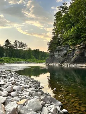 a river with rocks and trees on the shore at Peaceful Dome Getaway in the Catskills in Gilboa