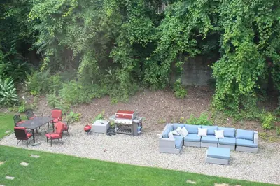 a backyard with a couch and chairs and a table at MODERN 1BR GREAT Location Downtown Parking in Albany